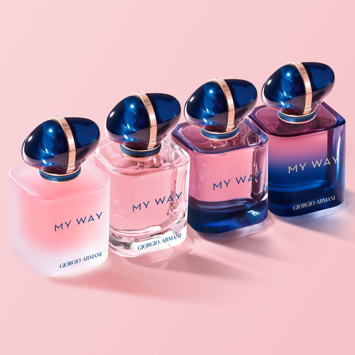 Four Giorgio Armani 'My Way' perfume bottles on a pink background
