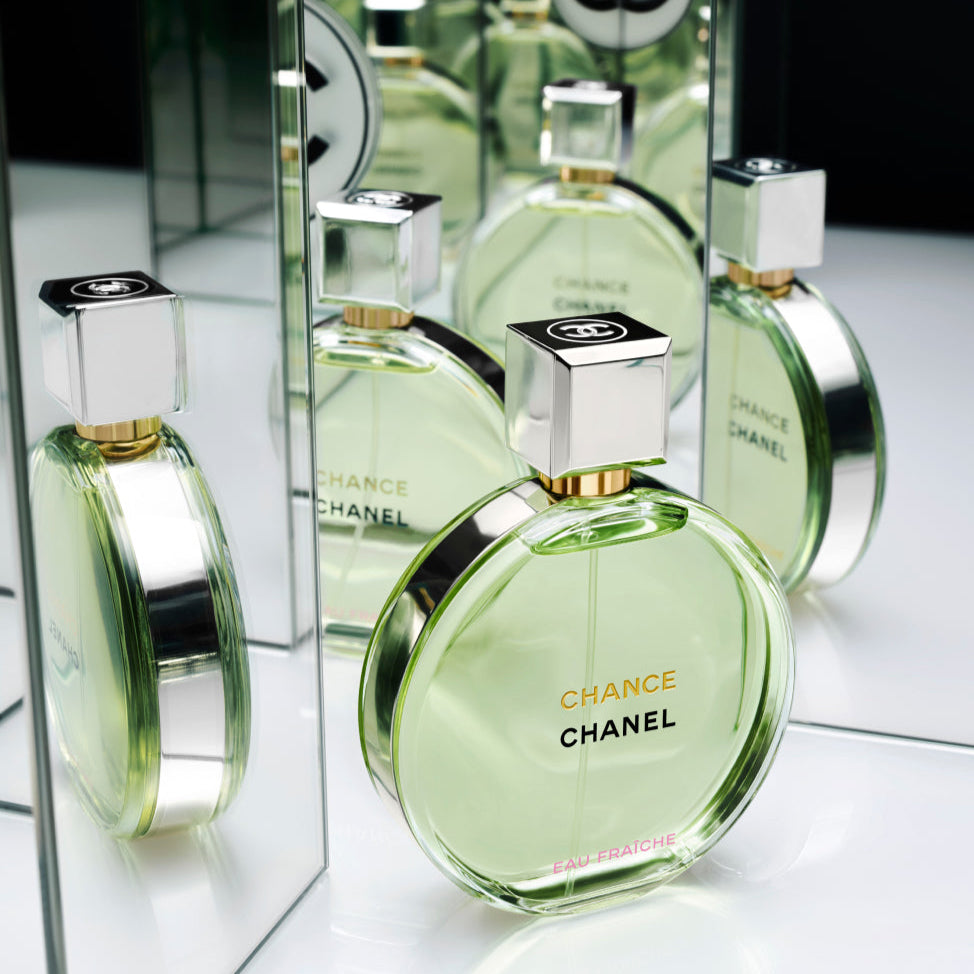 Chanel Chance perfume bottle with reflection on a mirror surface
