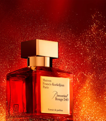 baccarat rouge 540 edp Perfume bottle with gold cap on a red glittery background