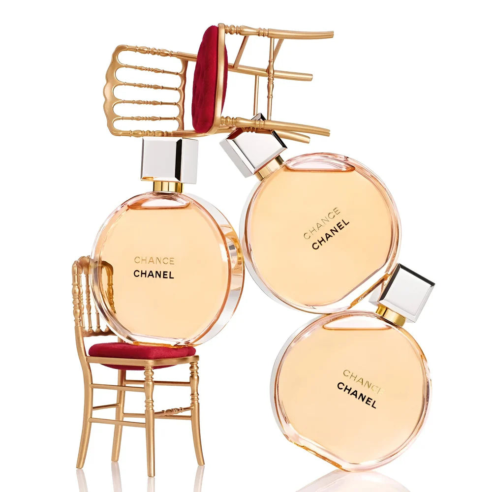 Chanel perfume bottles with a decorative chair on a white background
