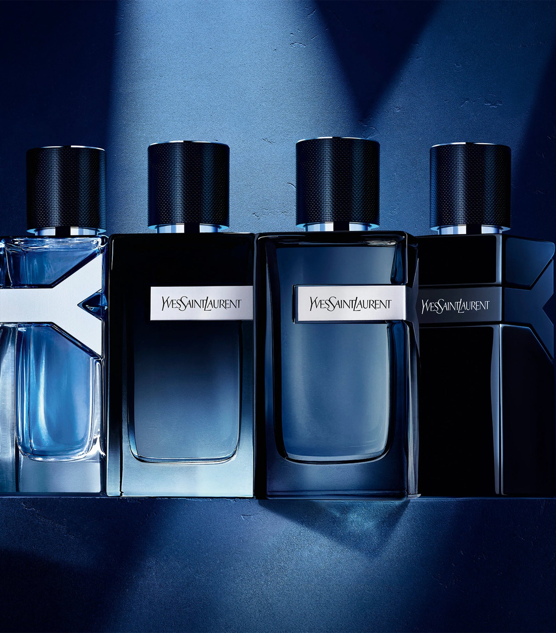  Yves Saint Laurent perfume bottles on a blue background
