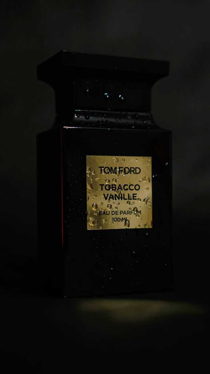 Tom Ford Tobacco Vanille perfume bottle with gold label on a dark background
