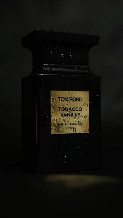 Tom Ford Tobacco Vanille perfume bottle with gold label on a dark background
