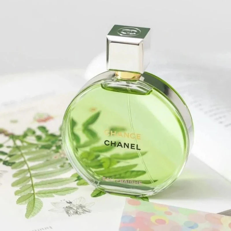 Chanel perfume bottle with green liquid on a white background
