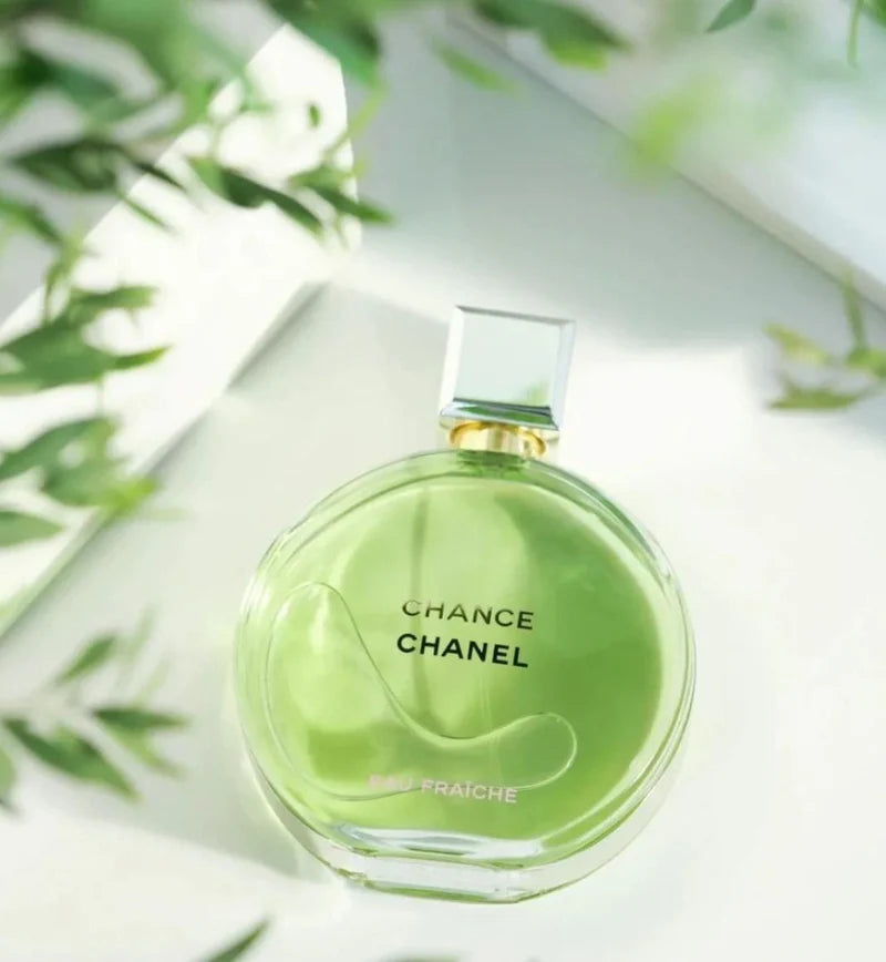 Chanel Chance perfume bottle with green packaging on a light background
