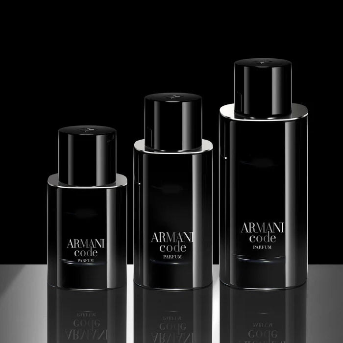 Three Armani Code perfume bottles on a reflective surface with a black background