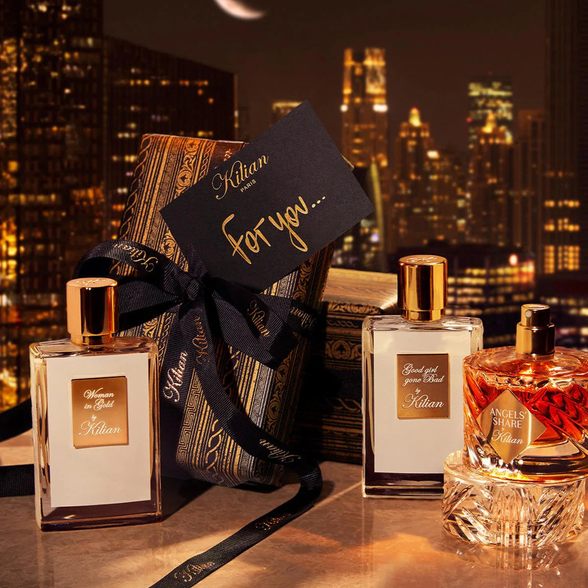 Kilian Paris perfume bottles with a gift box against a cityscape background and best women’s perfume Australia
